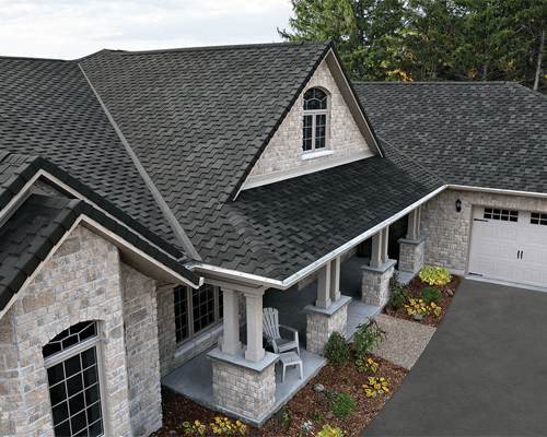 a house with a driveway and a lawn