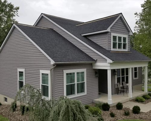 a house with a porch and a lawn