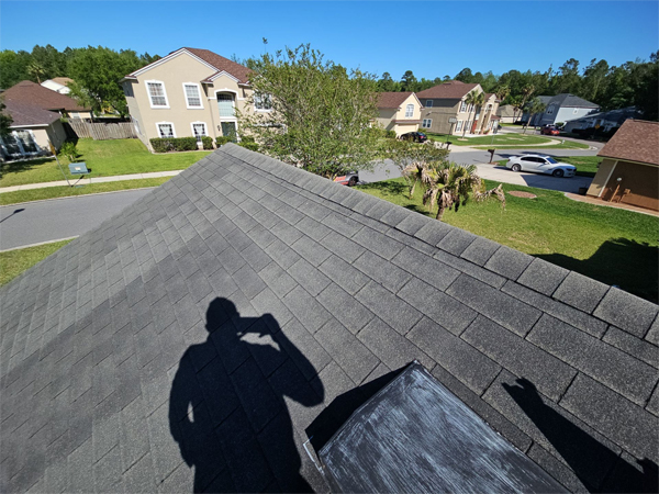 a shadow of a person on a roof